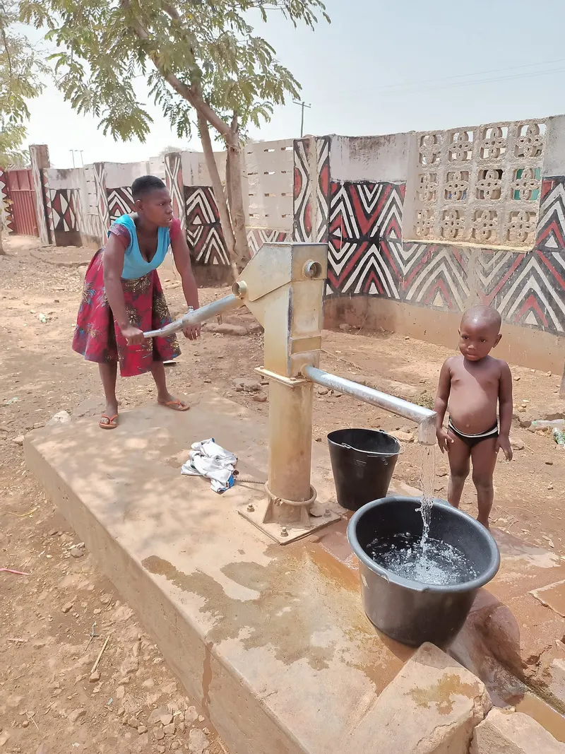 A woman fetching water from a borehole in Sirigu, Upper East Region